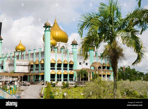 The Golden Domes And Towering Minarets Of The Kuching Mosque Sarawak