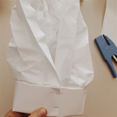 A diy paper chef hat: all you need is parchment paper, cardstock & 8 steps