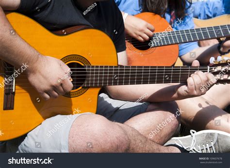 A Group Of Young People Playing Guitar Together Stock Photo 109607678