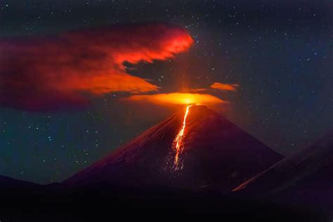 Volcano erupting at night