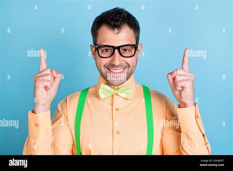 Photo Of Smart Brunet Young Man Point Empty Space Wear Peach Shirt