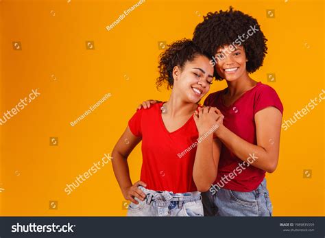 Afro Lesbian Couple On Yellow Background Stock Photo 1989835559 Shutterstock