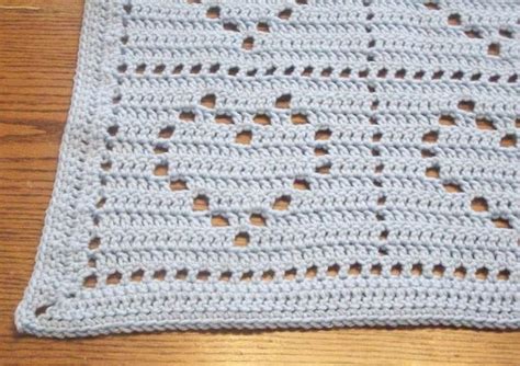 A Crocheted Dishcloth With Holes In The Middle On A Wooden Table Top