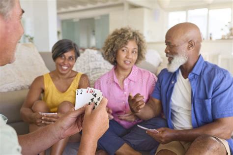 Group Of Mature Friends At Home Having Fun Playing Cards Together Stock Image Image Of Middle