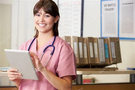 Nurse Using Digital Tablet At Nurses Station — Stock Photo ...