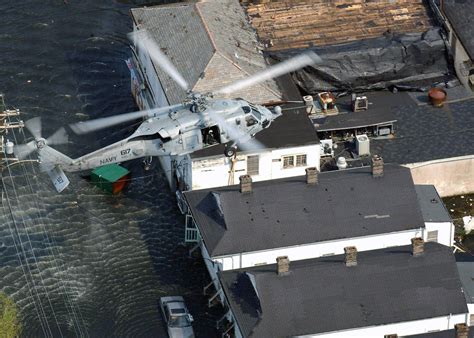 A Us Navy Usn Search And Rescue Swimmer Searches For Survivors Of