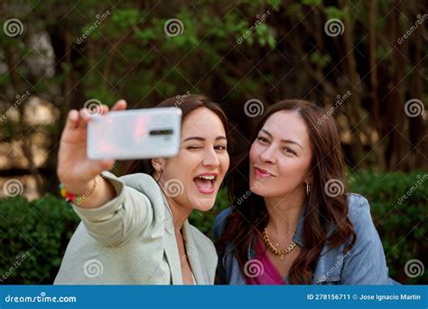 Two Women Taking A Selfie With A Mobile Phone Outdoors Stock Image