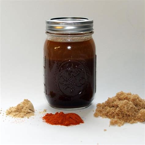 A Jar Filled With Lots Of Brown Stuff Next To Some Ground Cinnamons On