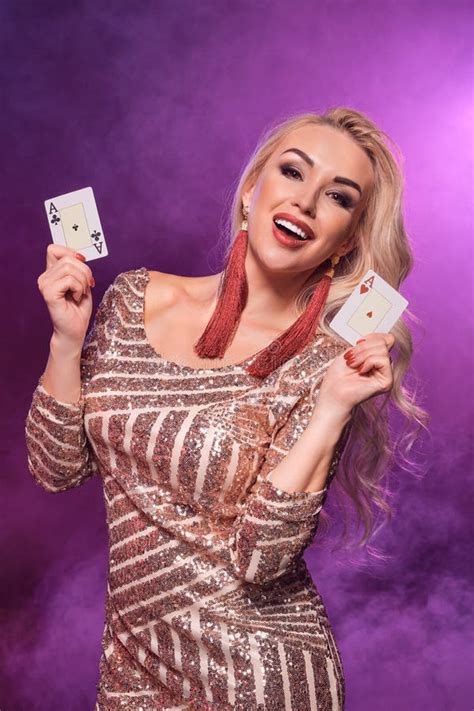 Blonde Woman With A Perfect Hairstyle And Bright Make Up Is Posing With Playing Cards In Her