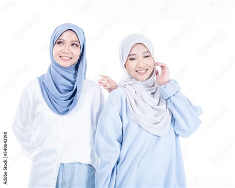 Portrait of two beautiful Muslim young women wearing modern and stylish ...