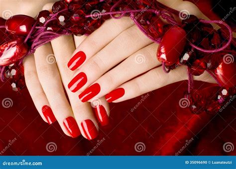 Close Up On Beautiful Female Hands With Red Manicure Stock Photo