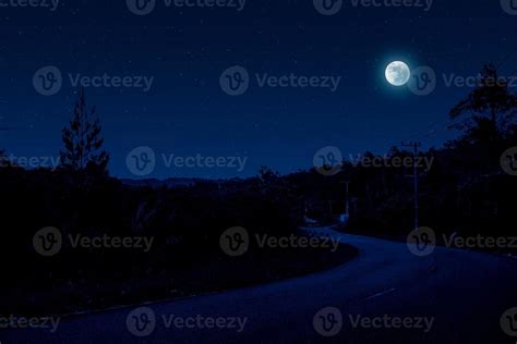 Night scene in village with empty road 12736105 Stock Photo at Vecteezy