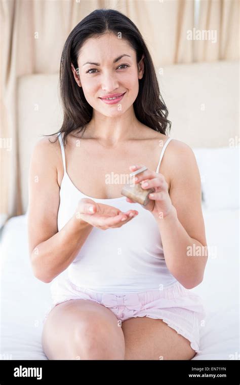 Pretty Brunette Using Body Cream On Bed Stock Photo Alamy