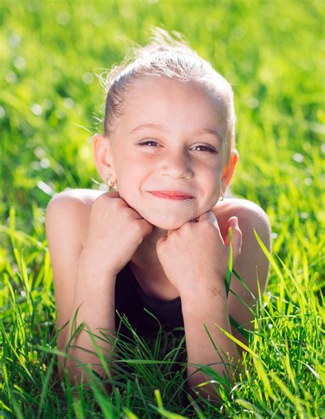 Cute Happy Little Girl Lying On The Grass Stock Photo Image Of