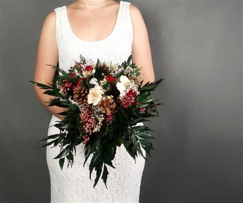 Cascading Winter Wedding Bridal Bouquet With Pine Cones Berries And