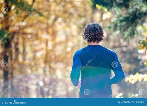 Young Handsome Runner Outside In Sunny Autumn Nature Stock Image