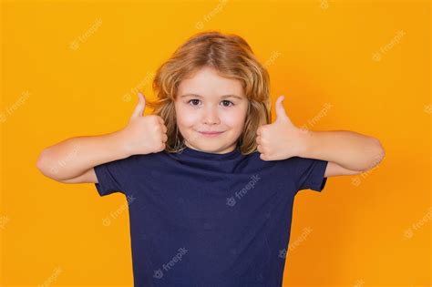 Premium Photo | Child showing thumbs up on studio isolated background ...