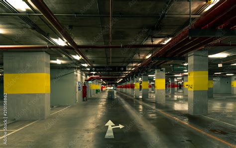 Perspective view of empty indoor car parking lot at the mall ...