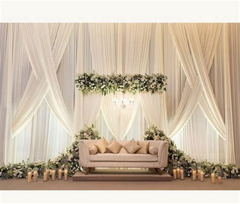 Elegant Wedding Decor with White Curtains and Flowers