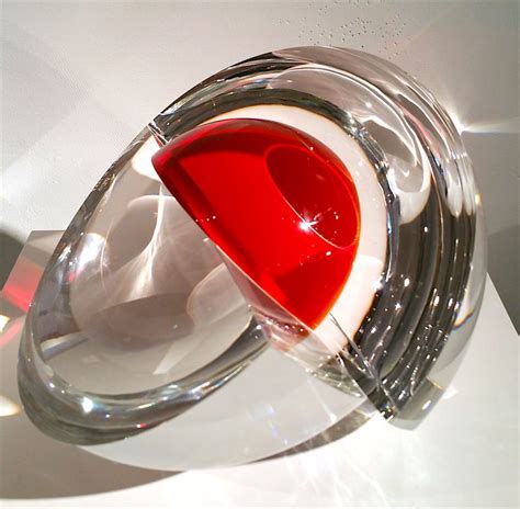 A Red And White Object Sitting On Top Of A Glass Table Next To A Wall