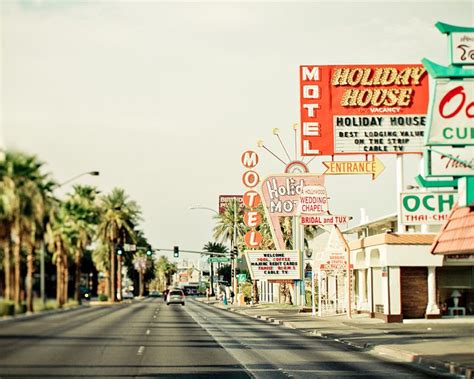 a street lined with lots of signs and palm trees