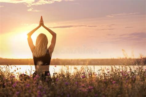 Young Woman Meditating Near River At Sunrise Back View Practicing