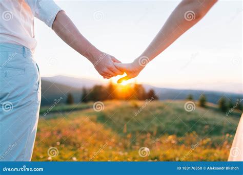 man  woman holding hands   sunset stock photo image