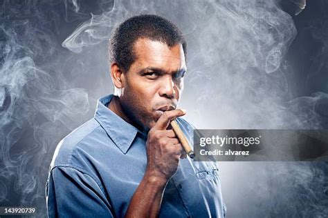 Black People Smoking Cigars Photos And Premium High Res Pictures