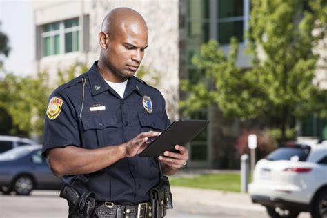 Police Officer Using Computer Tablet Geographic Technologies Group