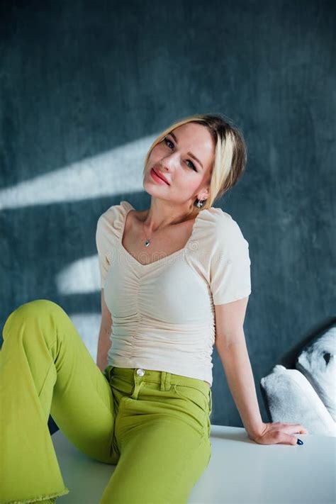 Beautiful Fashionable Slim Blonde Woman Sitting On A Chair Stock Photo Image Of Elegance