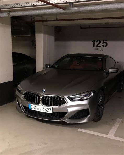 A Car Parked In A Parking Garage Next To Another Car