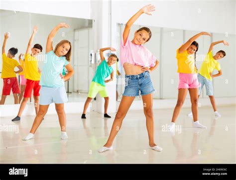 Group of kids training dance moves Stock Photo - Alamy