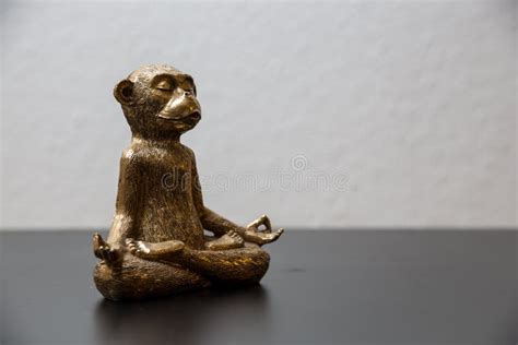 Closeup Shot of a Gold Monkey Statue on a Wooden Surface Stock Photo ...