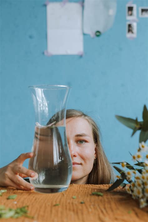 Woman Pouring Water In A Flower Vase · Free Stock Photo