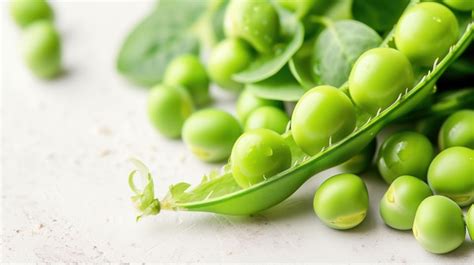 Premium Photo A Single Green Pea Pod Opens To Reveal The Fresh Peas