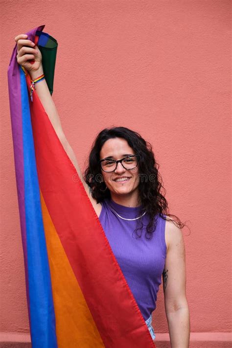 Lesbian Woman Is Holding A Rainbow Flag And Smiling Celebrating Pride Day Stock Image Image