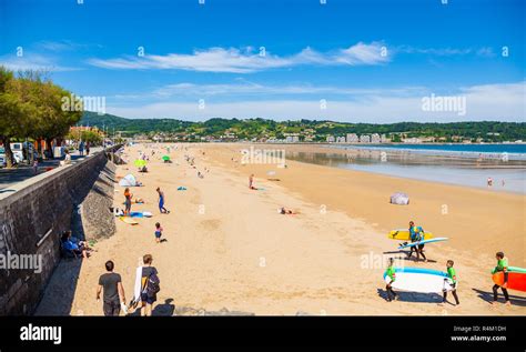 HENDAYE, FRANCE - JUNE 8: Tourists and surfers enjoy the beach of the charming seaside resort of ...