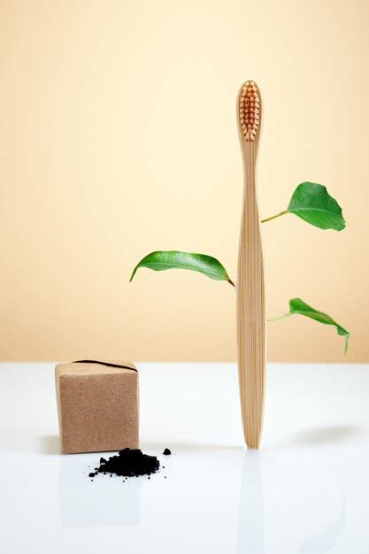 Premium Photo Wooden Bamboo Toothbrush With Leaves And Black Charcoal