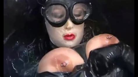 Girl With Big Boobs Encased In Black Rubber Latex Catsuit Enjoys Bucket Of Hot Cumm Part