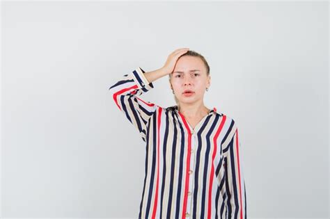 Free Photo Young Lady In Striped Shirt Holding Hand On Head And