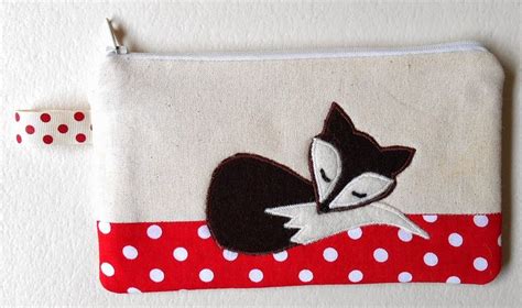 A Small Pouch With A Cat On It And Polka Dots Around The Edges Sitting