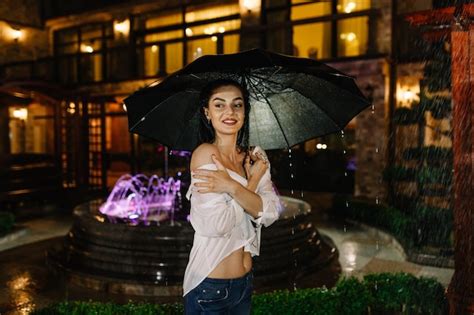 Premium Photo Cheerful Pretty Girl Holding Umbrella While Strolling