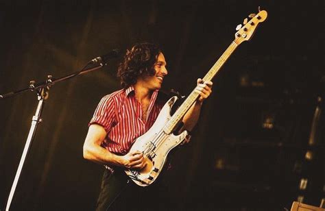 A Man That Is Standing Up With A Guitar