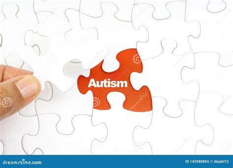 Hand Holding Piece of Jigsaw Puzzle with Word AUTISM Stock Image ...