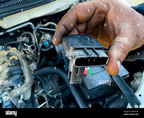 Manifold Absolute Pressure Sensor Map Holding In Hand For Examination