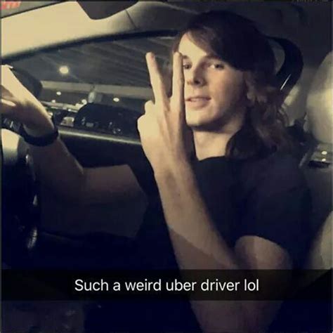 A Man Sitting In The Driver S Seat Of A Car Holding His Hand Up