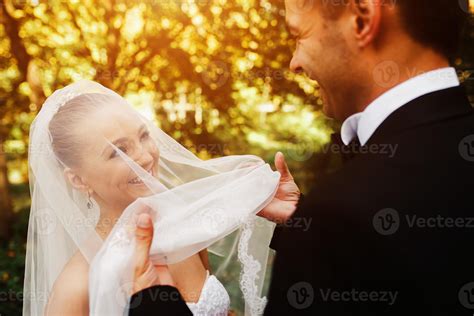 The Groom Lifts The Veil From The Bride 11434395 Stock Photo At Vecteezy