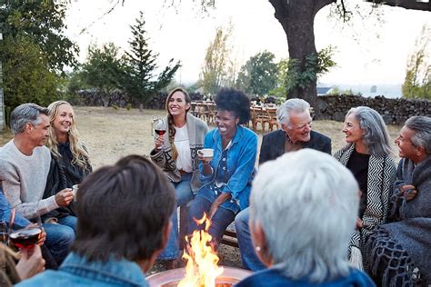 Group Of Friends Relaxing Around A Fire Pit At A Farm By Stocksy Contributor Trinette Reed