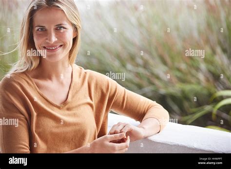 Portrait Smiling Blonde Woman On Patio Stock Photo Alamy