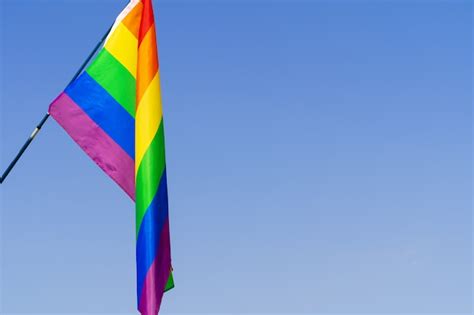 Premium Photo Gay Rainbow Flag Waving In The Wind In A Clear Blue Sky